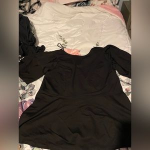 Eloquii size 22/24 black peplum top. “Poofy”-like sleeves.